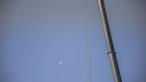 Timelapse-shot-of-crane-working-on-a-construction-site-in-a-fast-moving-moon-during-morning-time