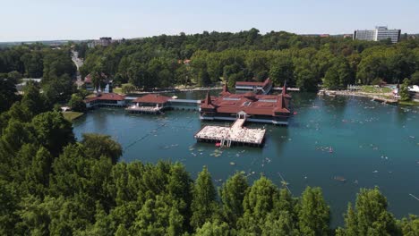 Aerial-reveal-shot-of-beautiful-architecture-in-the-He-viz-Lake-in-Hungary