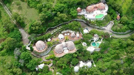 Aerial-top-down-of-magical-fantasy-dome-villa-in-the-rural-mountains