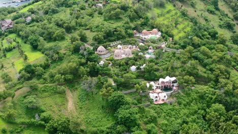 Aerial-top-down-view-of-luxury-white-dome-villa-complex-on-rural-mountain-on-Lombok-Island