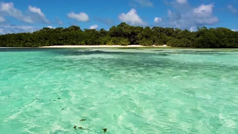 Clearwater-turquoise-near-shore-beach-caribbean-island,-los-Roques-Archipelago,-pan-left