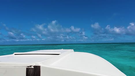 Fishing-boat-sailing-on-blue-water-caribbean-sea,-sight-from-inside-boat,-close-up