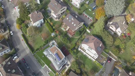 Lausanne-town-viewed-from-the-top,-Houses-in-a-residential-neighborhood-near-a-road,-gardens-and-trees-in-an-urban-environment