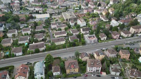 Aerial-view,-Tilt-up-with-drone:-Residential-area-in-Lausanne-town:-Houses,-buildings-and-the-view-on-the-geneva-lake,-capital-city-in-Vaud,-Switzerland