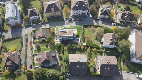 Houses,-buildings,-roads-and-garden-in-a-residential-area,-neighbourhood-Lausanne,-the-capital-city-in-Vaud,-Switzerland,-drone-aerial-view,-tilt-up