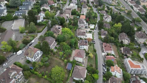 Panoramic-drone-aerial-view:-Residential-area-in-a-Lausanne-neighborhood:-Houses,-buildings-and-gardens
