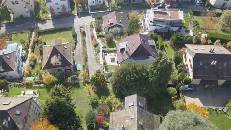 Drone-top-view:-Residential-area-in-a-Lausanne-neighbourhood,-town:-Houses,-buildings,-roads-and-trees-in-the-capital-city-of-Vaud,-Switzerland