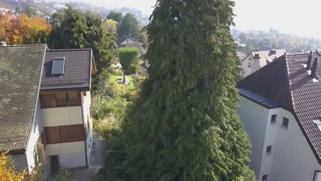 Panning-aerial-shot:-Lausanne,-residential-area-of-the-city-in-the-morning,-trees-and-houses,-urban-environment,-Switzerland,-Vaud