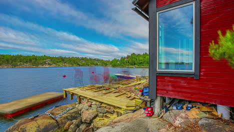 Time-lapse-of-two-people-building-a-wooden-porch-in-front-of-a-rustic-lake-house
