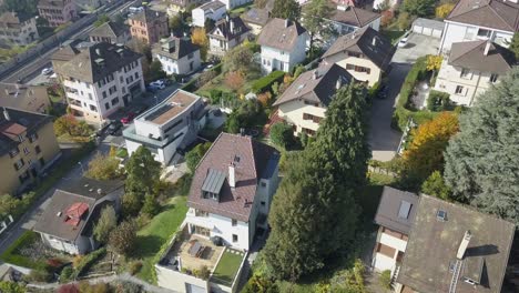 Drone-aerial-view:-Residential-area-in-Lausanne-town:-Houses-and-trees-in-the-capital-city-in-Vaud,-Switzerland
