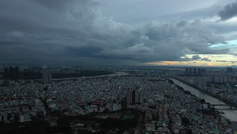 Saigon-or-Ho-Chi-Minh-City,-Vietnam-aerial-tracking-shot-on-very-dark-stormy-evening-1