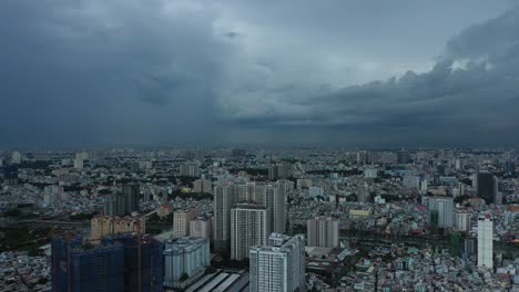 Saigon-or-Ho-Chi-Minh-City,-Vietnam-aerial-urban-view-to-large-apartment-buildings-on-very-dark-stormy-evening