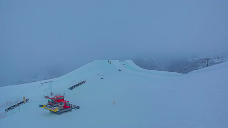 High-angle-shot-of-workers-building-Suzuki-Nine-Knights-ramp-in-Watles-ski-resort-on-a-cloudy-day-in-timelapse