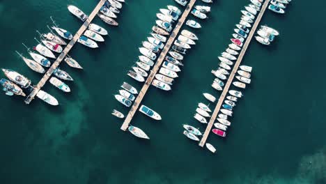 Top-town-drone-video-in-San-Antoni,-Ibiza-Island,-Spain-with-boats-and-harbour