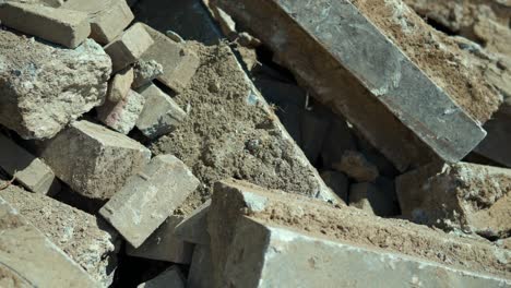 Consequences-of-Russia's-military-invasion-of-Ukraine-a-destroyed-residential-building-after-artillery-strikes-on-residential-house-piles-of-bricks,-remains-of-the-walls---details