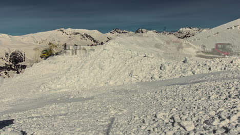 Timelapse-shot-of-snow-groomers-creating-snow-park-for-Suzuki-Nine-Queens-big-air-event-in-Serfaus,-Austria