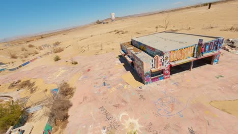 FPV-drone-shot-of-abandoned-Lake-Dolores-Waterpark-In-Mojave-Desert,-California