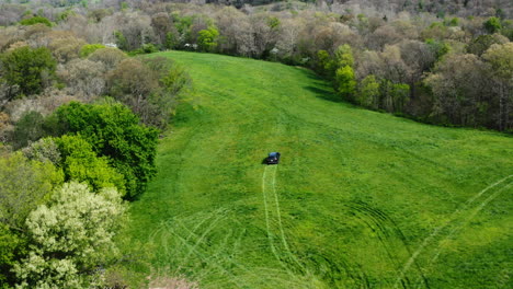 Vehicle-Driving-On-The-Green-Field-During-Land-Survey-Near-Siloam-Springs,-Arkansas,-USA---aerial-shot