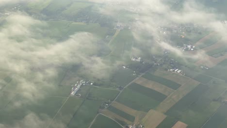 An-aerial-view-of-the-clouds-and-rural-farmland-in-the-green-of-summer