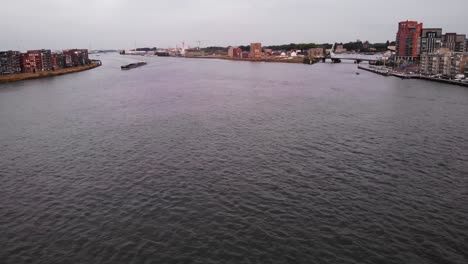 Panoramic-Shot-Of-Candesso-Cargo-Ship-Sailing-In-Middle-Of-Quiet-Noord-River,-South-Holland