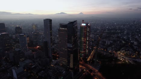 Aerial-view-in-front-of-illuminated-high-rise-at-the-Reforma-avenue,-in-Mexico-city