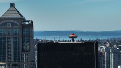 Rising-aerial-shot-revealing-the-Seattle-Space-Needle-on-a-warm-sunny-day