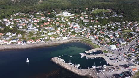 Aerial-view-of-Molle,-Sweden-in-the-summer,-showing-a-marina-and-boats