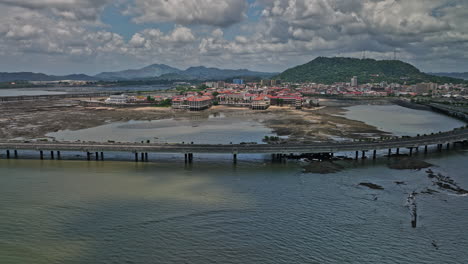 Panama-City-Aerial-v98-cinematic-flyover-water-bay-capturing-cinta-costera-3-coastal-beltway-and-historic-district-casco-viejo-with-ancon-hill-in-the-background---Shot-with-Mavic-3-Cine---April-2022
