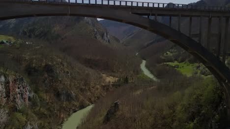 Drone-footage-flying-under-the-Durdevica-Tara-Bridge-and-through-the-valley-in-Montenegro