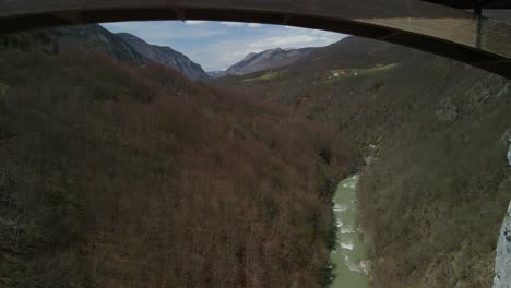 Drone-footage-flying-under-Durdevica-Tara-bridge-toward-the-mountains-in-Montenegro
