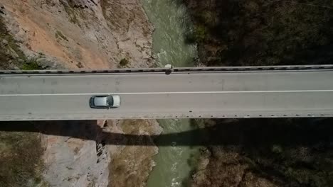 Drone-footage-looking-straight-down-at-cars-driving-across-the-Durevica-Tara-Bridge-in-Montenegro