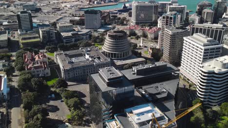 Drone-fly-to-Beehive,-New-Zealand-parliament-building-in-Wellington