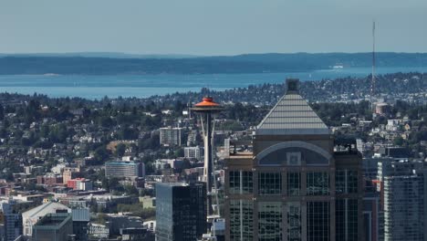 Aerial-view-revealing-the-Seattle-Space-Needle-with-an-orange-top-to-commemorate-its-60th-year