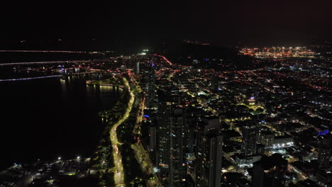 Panama-City-Aerial-v61-drone-fly-along-coastal-avenue-at-calidonia-neighborhood-leading-to-cinta-costera-capturing-gleaming-high-rise-towers-and-night-cityscape---Shot-with-Mavic-3-Cine---March-2022
