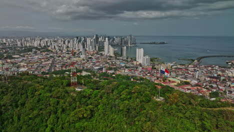 Panama-City-Aerial-v24-flyover-ancon-hill,-panoramic-panning-view-capturing-cityscape-across-downtown-metropolitan-and-historic-district-and-amador-neighborhood---Shot-with-Mavic-3-Cine---March-2022