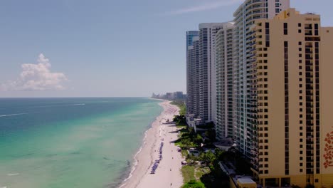 Aerial-Sunny-Isles-Beach-skyline-in-Sunny-Isles,-Florida-Drone-Rise-Movement
