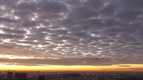 Dramatic-Cloudy-Sky-With-Aircrafts-Flying-Over-City-Of-Toronto-At-Sunrise-In-Ontario,-Canada