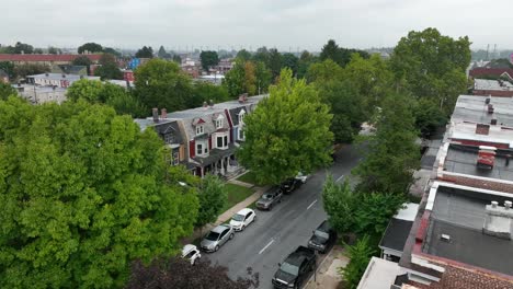 Aerial-drone-shot-of-colorful,-residential-townhomes-on-a-foggy-summer-morning