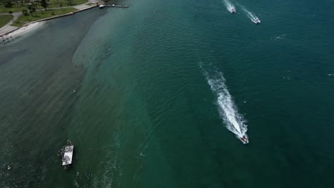 Aerial-Footage-of-Boats-Passing-While-Looking-Down-on-Loxahatchee-River-in-Florida