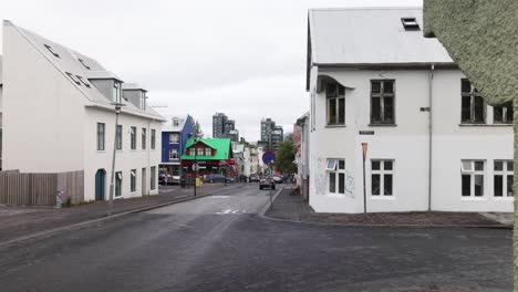 Downtown-neighborhood-and-car-driving-in-Reykjavik,-Iceland-with-gimbal-video-walking-forward