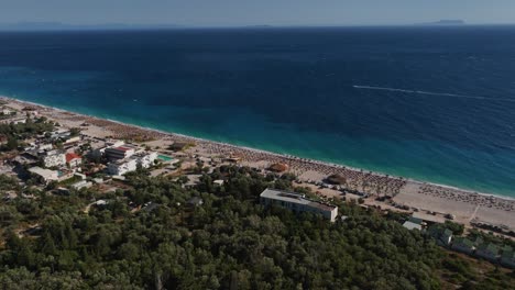 Aerial-view-towards-the-Perivolos-beach-on-the-Albanska-riviera,-in-sunny-Dhermi,-Albania