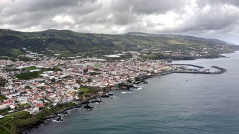 Seaside-town-on-Atlantic-coast-of-Azores-on-cloudy-day,-aerial-view