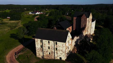 Aerial-view-around-the-Kastelholma-castle,-summer-evening,-in-Ahvenanmaa,-Finland---orbit,-drone-shot