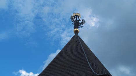 Crow-flying-by-den-bosch-old-city-coat-of-arms-ducal-crown-on-top-of-gabled-roof