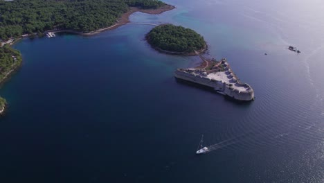 Old-defence-fort-in-Adriatic-sea,-Venetian-fortress-in-coastal-landscape-of-Croatia,-aerial