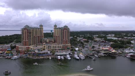 Drone-view-flying-down-the-side-of-Harborwalk-Village-in-the-harbor-of-Destin-Florida