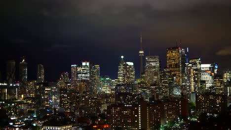 Illuminated-Toronto-city-skyline-lights-at-night---high-angle-panning-left