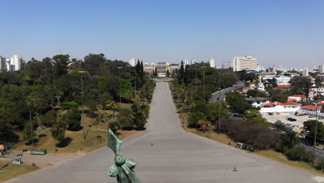 Aerial-shot-craning-down-revealing-the-Independence-Monument-in-the-Independence-Park-with-the-Ipiranga-Museum-in-the-background-of-the-scene