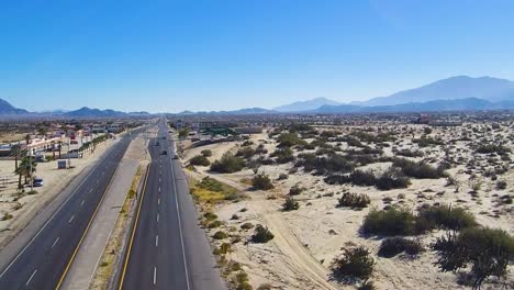 View-of-a-drone-flying-over-the-highway-of-a-small-town