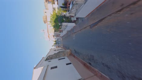 Vertical-Shot-Of-An-Empty-Street-With-Cobbled-Stone-Road-During-Sunny-Day-In-Calle-Padre-Billini,-Dominican-Republic